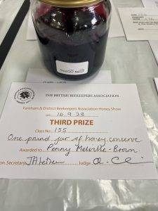 One jar of clear dark purple jelly with certificate.