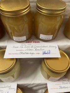 Two jars of yellowy orange sticky stuff and certificate.