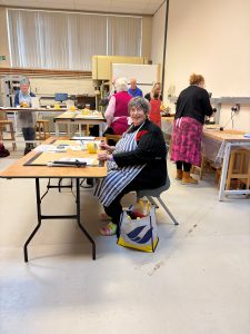 Penny in the workshop making a luminaire